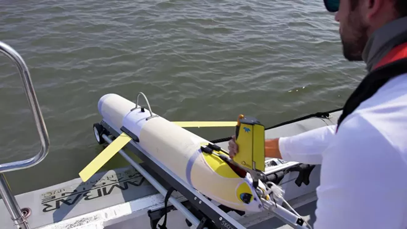 UGA Skidaway Institute research technician Ben Hefner launches a glider into the ocean.