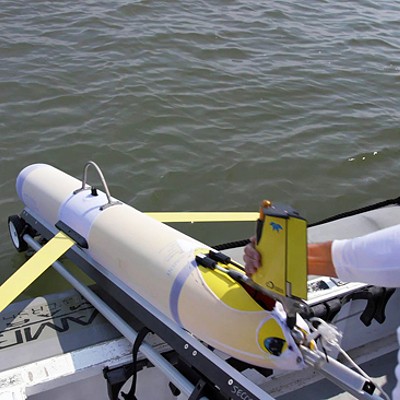 UGA Skidaway Institute research technician Ben Hefner launches a glider into the ocean.