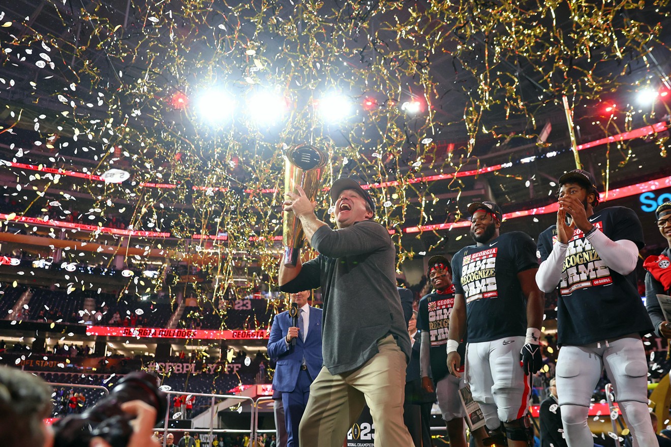 Georgia Bulldogs head coach Kirby Smart holds the trophy after winning the CFP national championship game against the TCU Horned Frogs at SoFi Stadium. PHOTO: Mark J. Rebilas