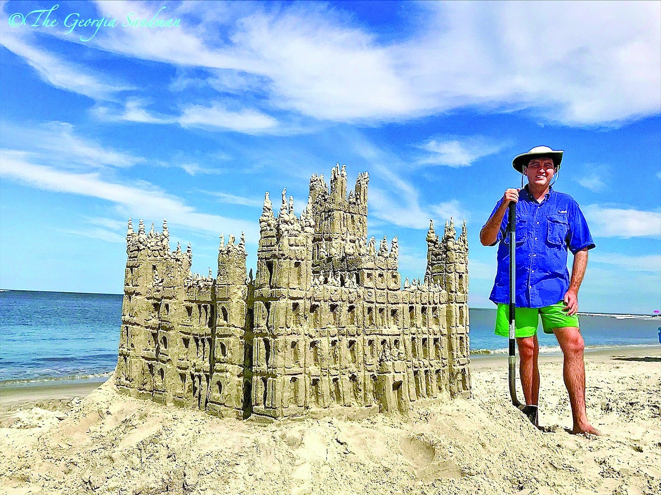“The Georgia Sandman” Dylan Mulligan poses with one of his favorite sand-builds, Highclere Castle, the famous dwelling from the hit television program “Downtown Abbey.”