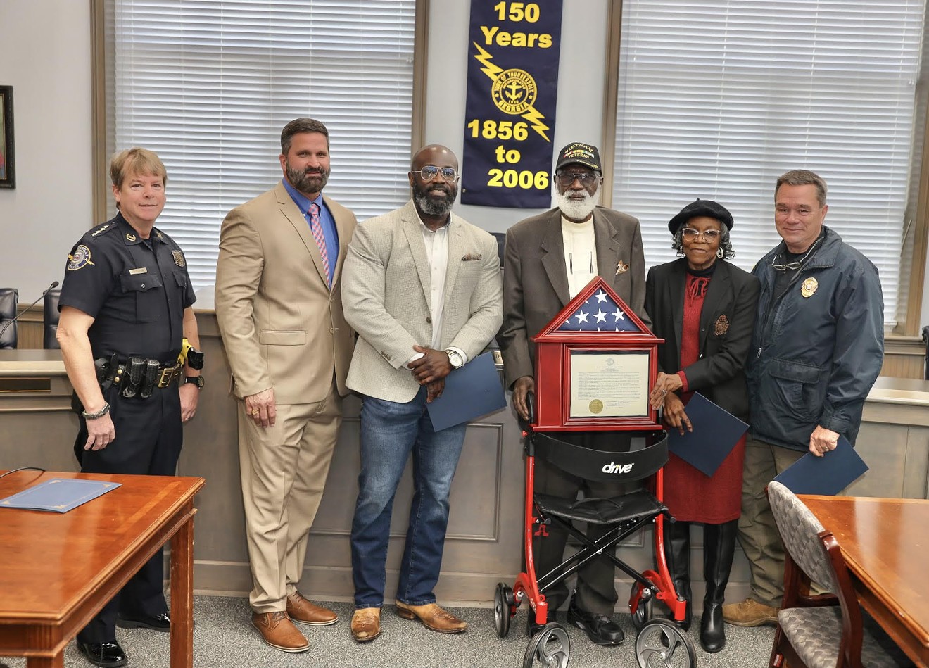 Mr. Ben Green (with hat) poses for a photo with Thunderbolt Mayor Dana Williams and police department staff.